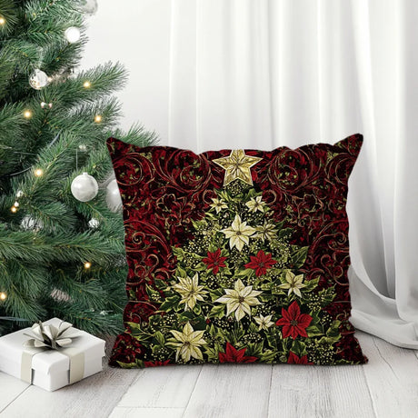 Sierkussen met een kerstboom van bloemen en rijke rode tinten.