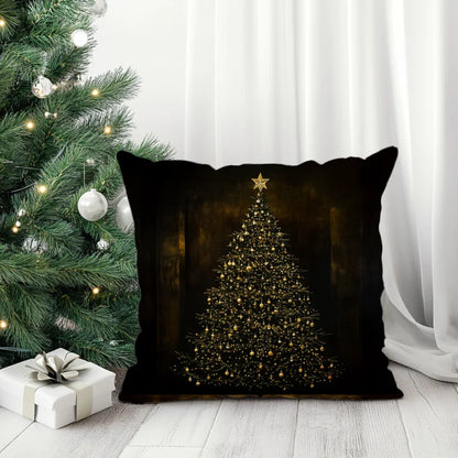 Donker sierkussen met een verlichte kerstboom in warme tinten.